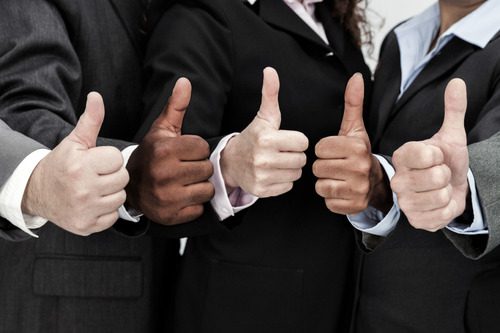 A group of people giving thumbs up to the camera.