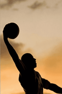 A person holding onto a basketball in the air